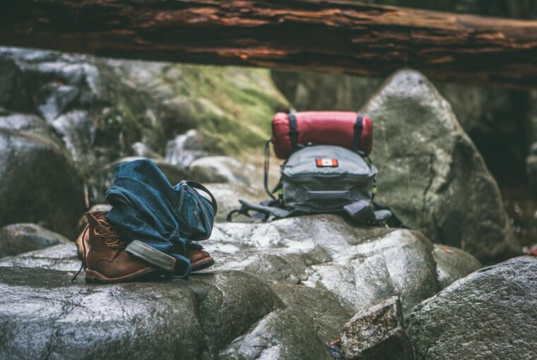 two gray and orange backpacks on gray rocks at daytime