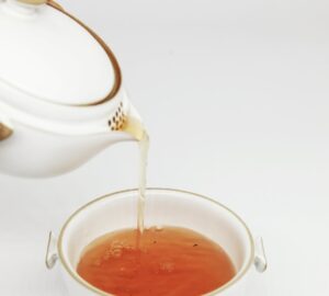 tea pours into white teacup