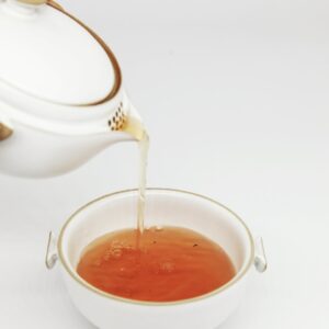 tea pours into white teacup