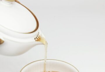 tea pours into white teacup