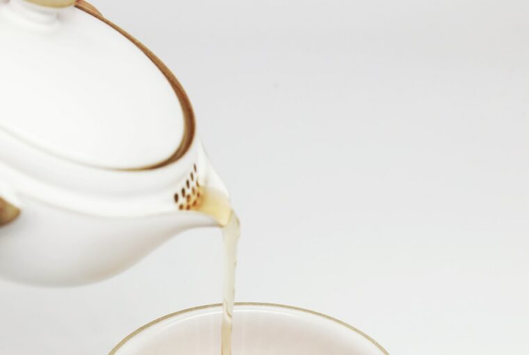 tea pours into white teacup